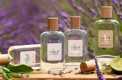 4 fresh faces models—2 men and 2 women— in beach attire standing in front of a mountain